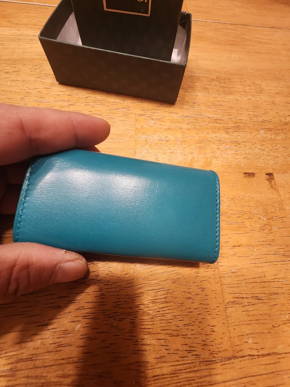 vintage Gucci teal leather key case featuring a distinctive cabochon stone